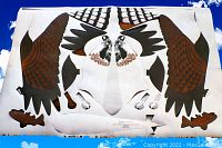 Photo showing the kite layout flat with detailed osprey bird pattern including wings, tail, and fish graphics.