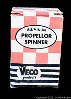 Photo of VECO branded box with checkered red and white pattern, labeled Aluminum Propellor Spinner.