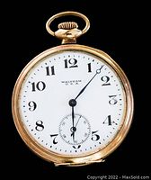 Front face of the watch showing white dial with black numerals and sub-second dial.