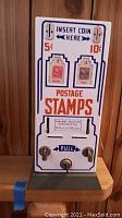 Front view showing coin slots, stamp graphics (5¢ and 10¢), postage stamps label and pull lever