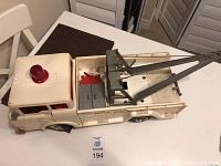 Full side view of white Marx Big Bruiser Super Highway Service Wrecker Tow Truck showing crane, cab with red light, and text decals on side