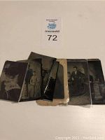 Photo of roughly 5 antique metal photographs arranged horizontally, showing various group and individual portraits in black and white or sepia tone.