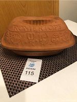 Full view of the clay baker with lid showing embossed decorative designs and the Romertopf brand name on the lid.