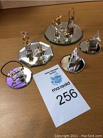 Overview of all crystal figurines and mirrors on wooden surface
