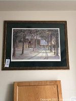 Framed print of winter scene titled Silent Night by Trisha Romance shown on wall