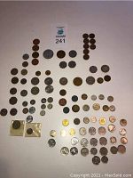 Overview photo showing multiple coins laid out, ranging in sizes, metals and designs.