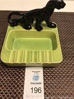 Photo showing the entire panther ceramic ashtray with green base and black glossy panther figure.