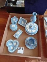 Full set of 8 pieces: demitasse cup & saucer, 1 small vase, 1 covered jar, 4 decorative boxes in various shapes.