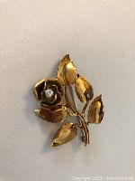 Front view of brooch showing rose and leaves
