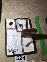 Overall view of three jewelry pieces arranged in tray