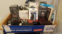 Box showing multiple Droid X accessories and related electronic items