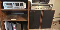 Wide view of shelf containing Onkyo cassette deck, receiver and two wood-cabinet speakers