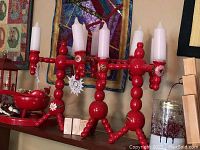 Red Swedish-style wooden Christmas candle lamp holding five white candles, decorated with white painted flowers
