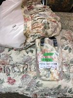 Photo of floral bedspread, bed skirt and pillows showing colors and ruffle details