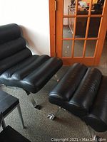 Front view of lounge chair and ottoman side by side showing overall design