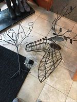 Photo showing all items: wire metal deer head, wire candle holder tree, and clear decorative candle rings on tile floor.