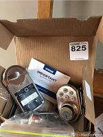 Weiser SmartCode door lock keypad, electronic module, and instructions inside cardboard box.