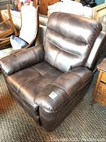 Front view of brown leather rocker chair showing seat, arms and backrest