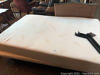 White memory foam mattress on bed frame, showing size and general condition.