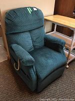 Front view of teal electric recliner chair showing overall condition