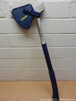 Full view of the 26 inch Estwing axe with blue comfort grip and blue protective sheath on the blade.