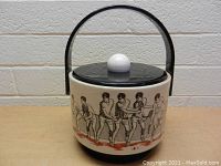 Front view of the ice bucket showing the tennis player illustrations around the body, black handle, and lid with white knob.