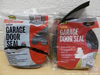 Lot of 2 garage door seals packaged in manufacturer plastic bags, showing brand MDI and product information.