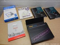 Wide view of all paper products laid out on table showing variety of brands and types