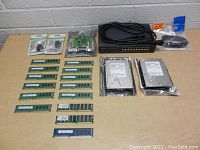 Full overview of all items in the lot including RAM, hard drives, network switch, cables, and adapters