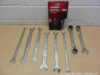 Husky wrenches arranged showing sizes and condition alongside their original packaging of a quad drive ratcheting wrench.
