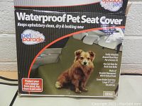 Close-up photo of the boxed Pet Parade Waterproof Pet Seat Cover showing the product details and key features on packaging.