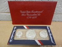 Set of three silver uncirculated bicentennial coins in original plastic display and red presentation folder