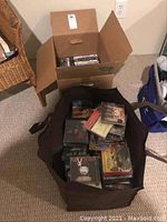 Large bag filled with various CDs showing album covers and discs