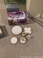 Full lot including Easy Bake Oven box and Noritake china place setting on beige carpet near corner wall