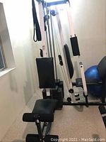 Full view of Weider 9400 Pro exercise machine showing padded seat, leg rollers, and frame near window.