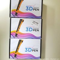 Three Ataraxia Art 3D printing pens stacked in their original retail boxes showing colorful branding and pen image.