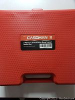 Red plastic carrying case with Casoman label describing the set as 7 pieces 1/2-Inch Drive Deep Impact Socket Set