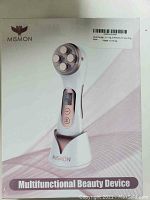 Packaged box front showing MiSMON brand multifunctional beauty device image and product name.