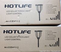 Boxed Hotlife LED solar torch light packaging, showing product name, image, and included installation accessories list.
