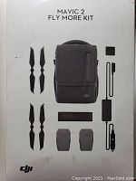 Front of sealed retail box showing kit layout: bag, propellers, batteries, hub, chargers and cables