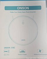 Box front showing Onson J10C round smart vacuum cleaner outline and features: ultra-thin, medium carpet suitability, 2000Pa suction.