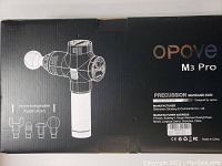 Box showing Opove M3 Pro massage gun with illustrations of interchangeable applicator heads.