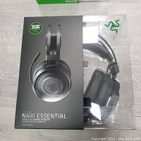 Front view of the sealed Razer Nari Essential headset box showing headset image, THX logo, and branding.