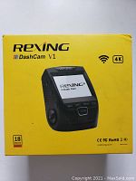 Front of the yellow Rexing DashCam V1 retail box featuring a photo of the camera, WiFi and 4K capability icons, warranty info, and certifications.