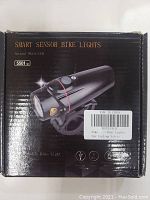 Front packaging showing smart sensor bike light - model 5501 with mounting bracket and branding details.