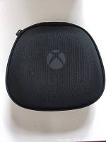 Closed black carrying case with Xbox logo on top, showing exterior condition.