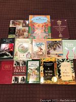 Photo of 13 classic story books laid out on a dark brown surface, showing all titles and front covers clearly.