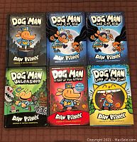 Six Dog Man series hardcover books arranged in two rows, covers fully visible showing titles and author Dav Pilkey.