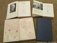 Four books opened to title page and some interior pages showing illustrations and text.