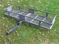 Side angle of the Curt steel basket-style cargo carrier with mesh base and straight square shank.